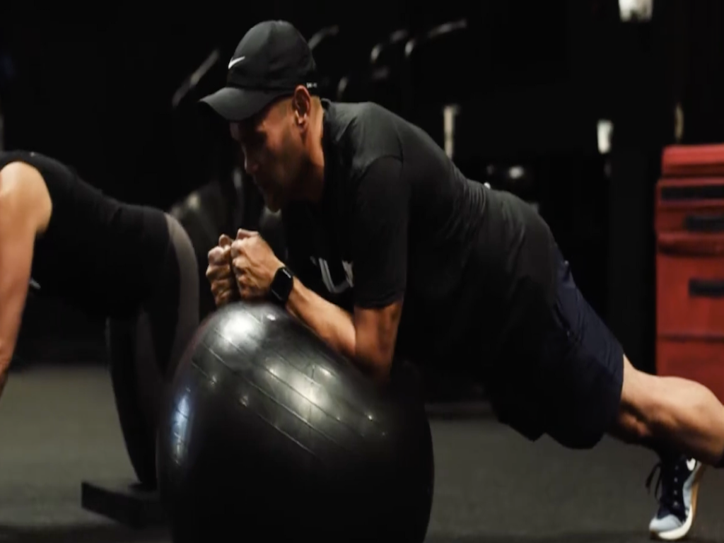 Member training at a Placentia personal training gym after overcoming a sedentary lifestyle