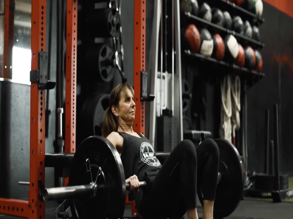 Senior member performing a strength training exercise at a Placentia personal training gym